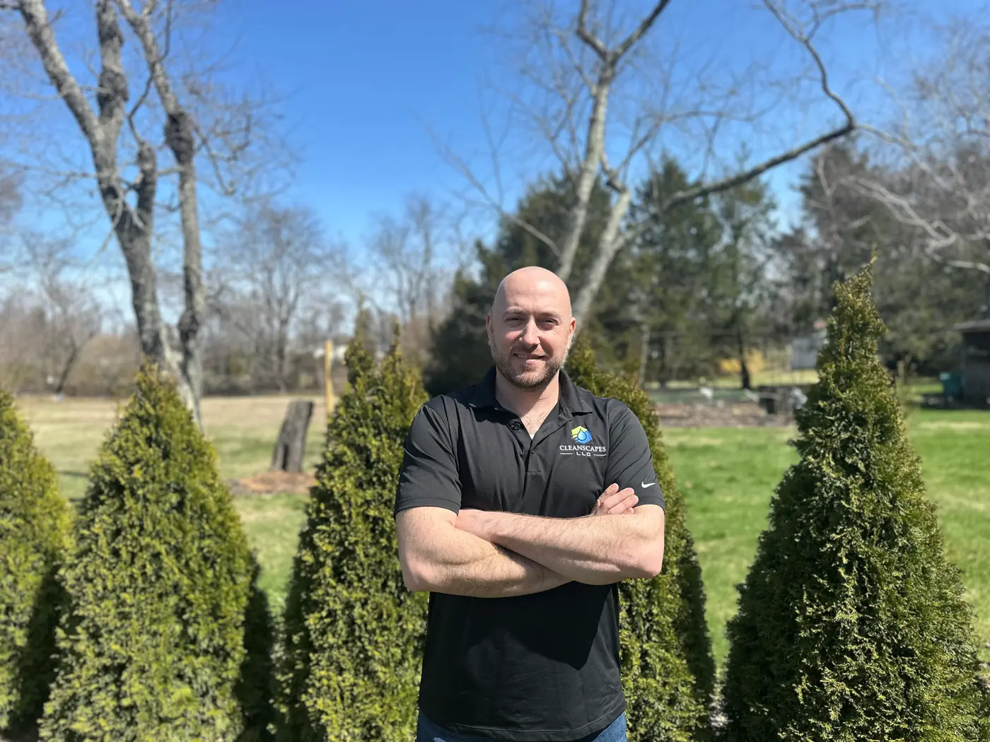 Andrew Fortin, owner Andrew Fortin, owner and operator of CleanScapes LLC, standing between arborvitae in Connecticut