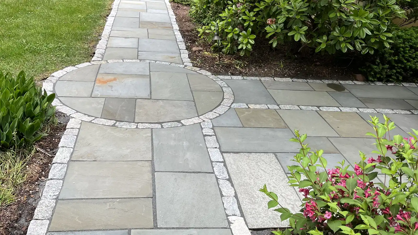 Bluestone and azaleas, Avon Bluestone walkway with a circle inlay and cobble border beside blooming azaleas in Avon, CT
