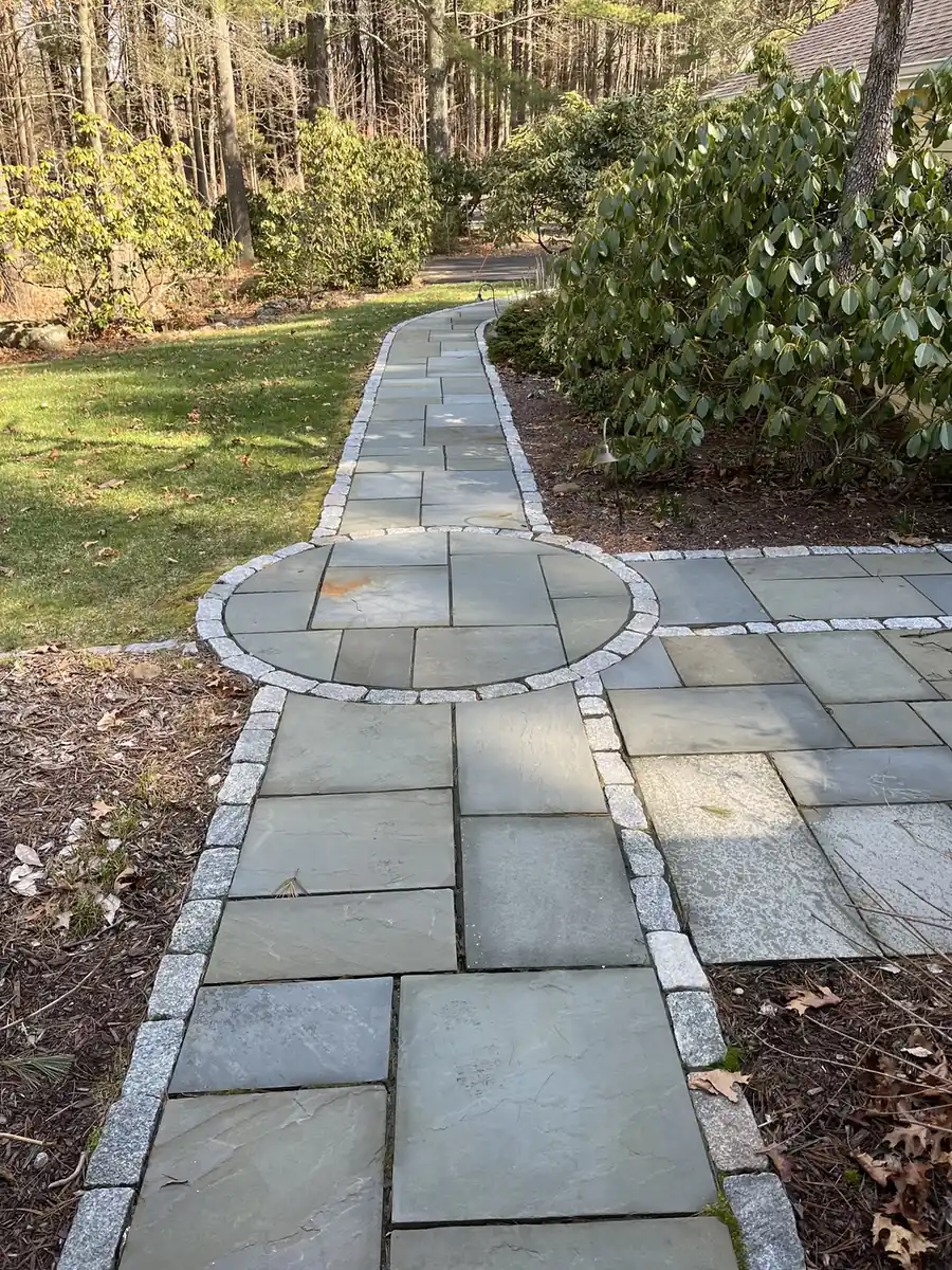 Bluestone walkway with a circular inlay and granite cobble border after cleaning in Avon, CT