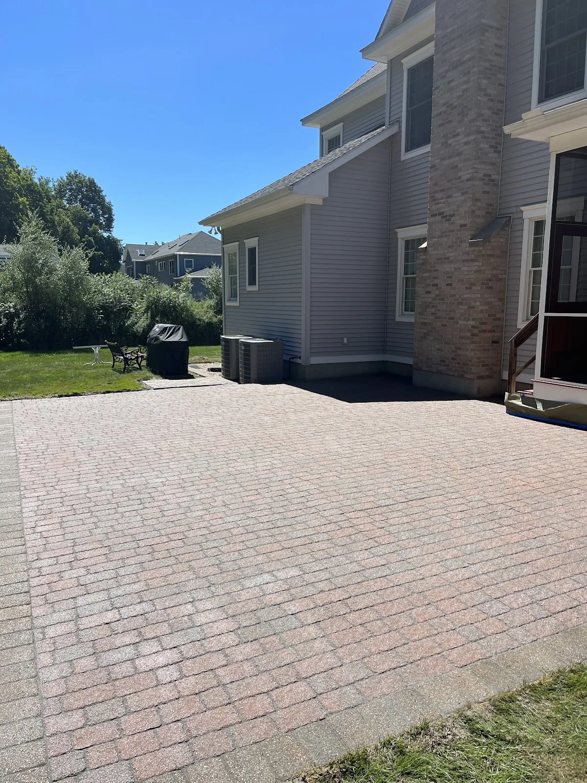 Paver patio behind house Clean paver patio behind a house after patio cleaning in Northwest Connecticut