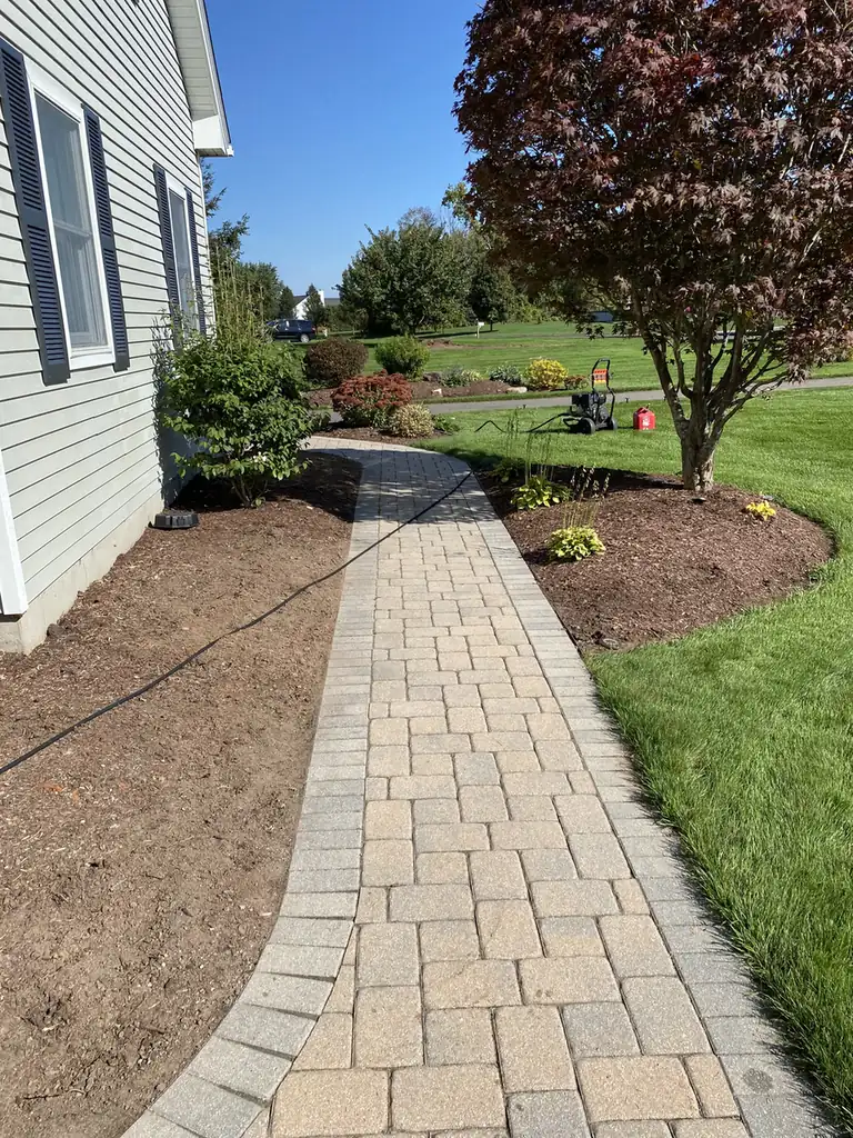 Side path, East Windsor Long cobble paver side path with a gray border along a house in East Windsor, CT