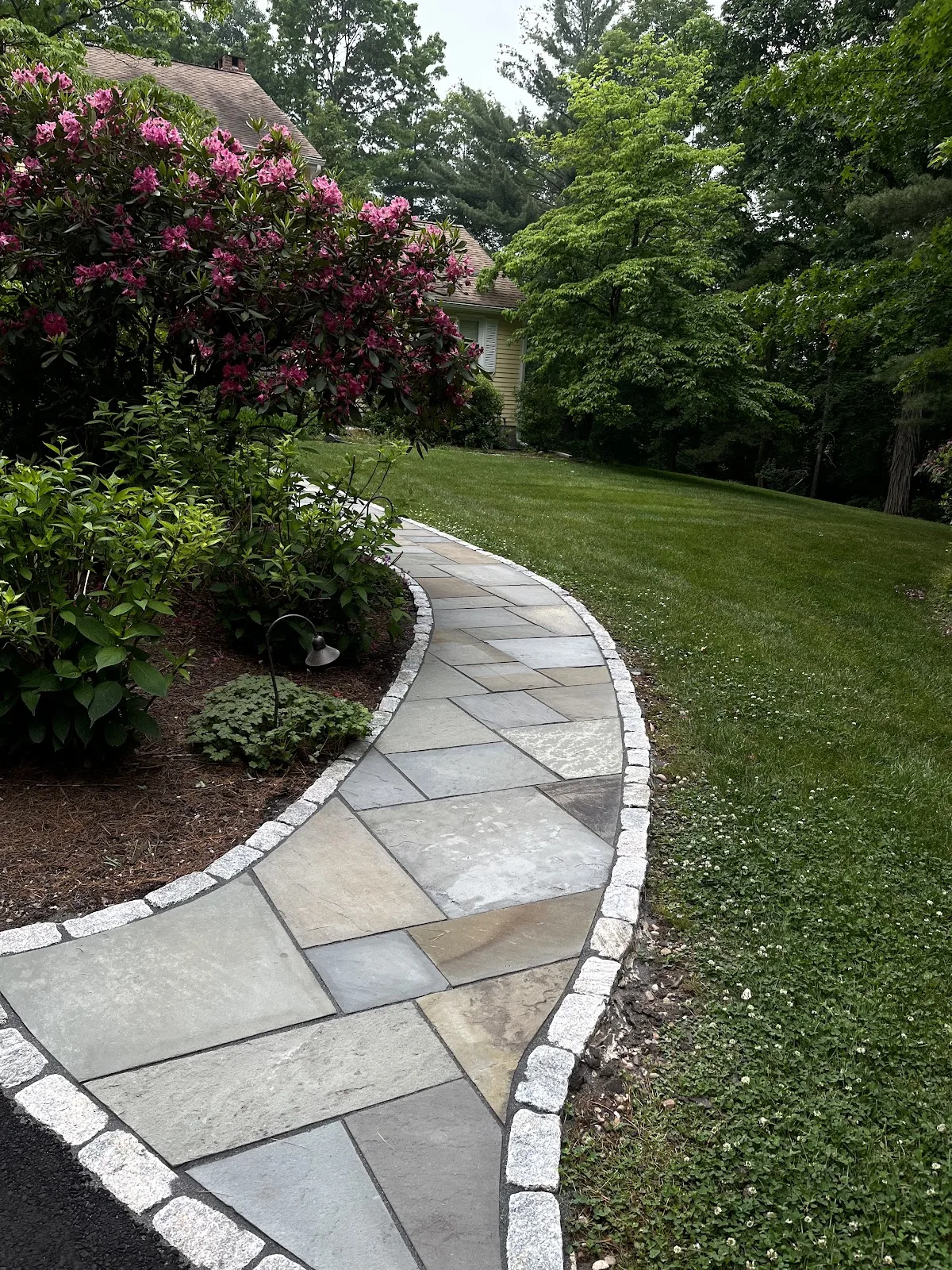 Curved bluestone walkway after hardscape sealing in Northwest Connecticut