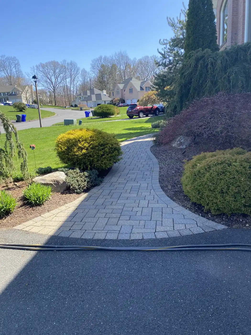 Curved paver walkway cleaned and re-sanded where it meets the asphalt driveway in Rocky Hill, CT