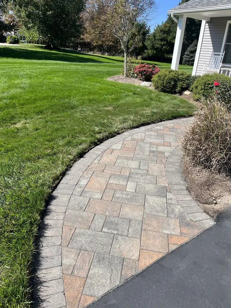 Curving walkway, Columbia Curving paver walkway crossing the lawn to a columned front porch in Columbia, CT