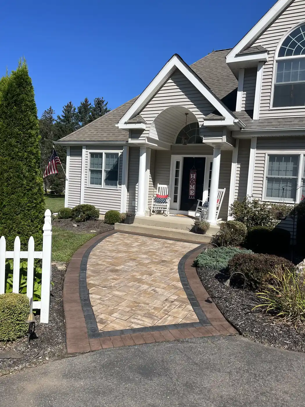 Front walk, Burlington Tan paver front walk with a red and charcoal double border at a colonial home in Burlington, CT