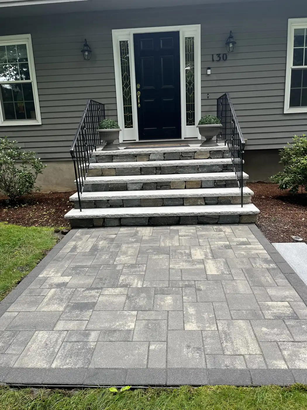 Paver entry landing and stone steps cleaned at the front door of a home in Simsbury, CT