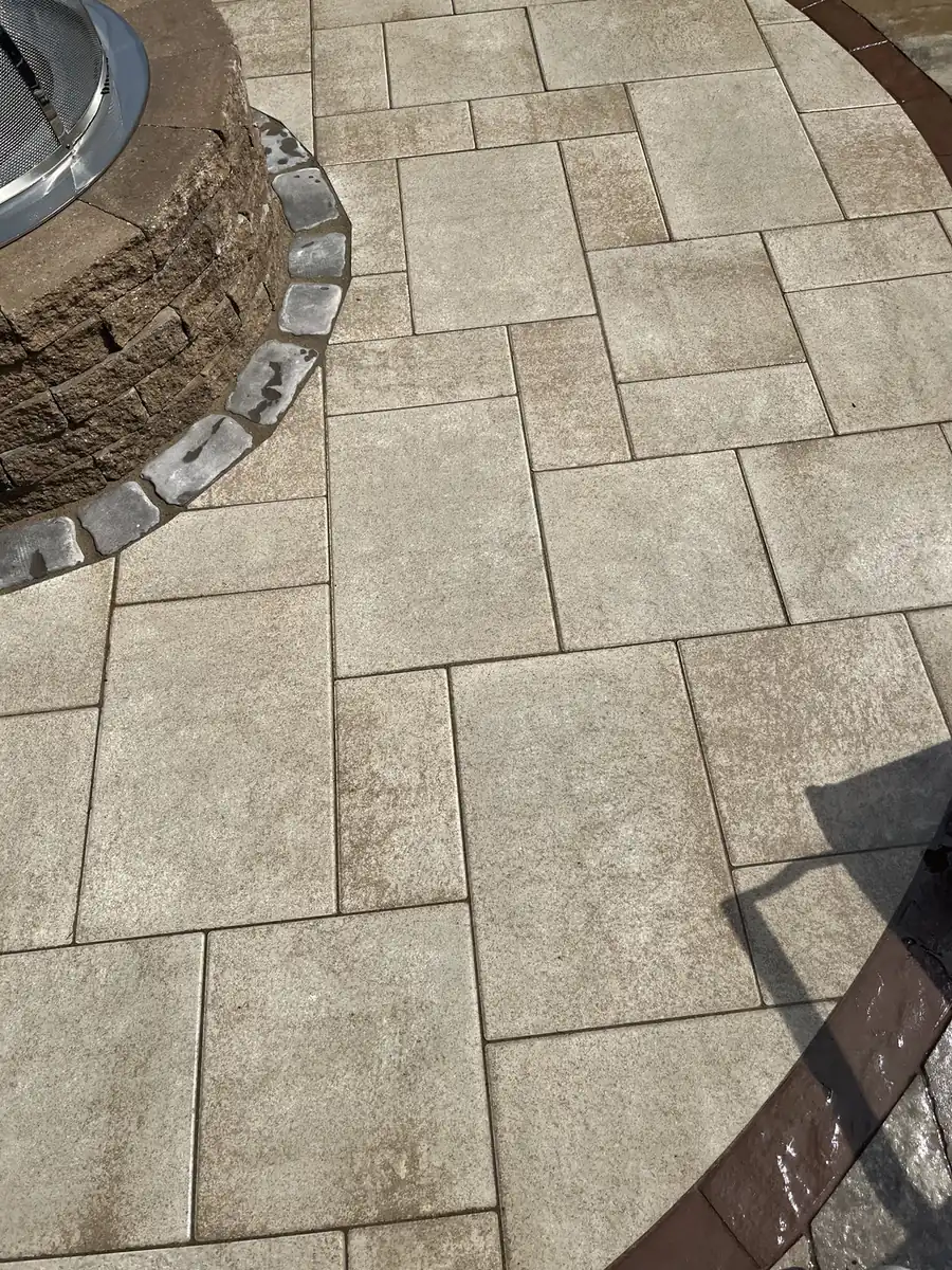 Pavers at a fire pit base Close-up of cleaned slab pavers meeting a stone fire pit base on a patio in Bristol, CT