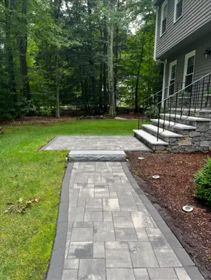 After cleaning and re-sanding: the same slab paver walkway with a charcoal border and clean joints in Connecticut