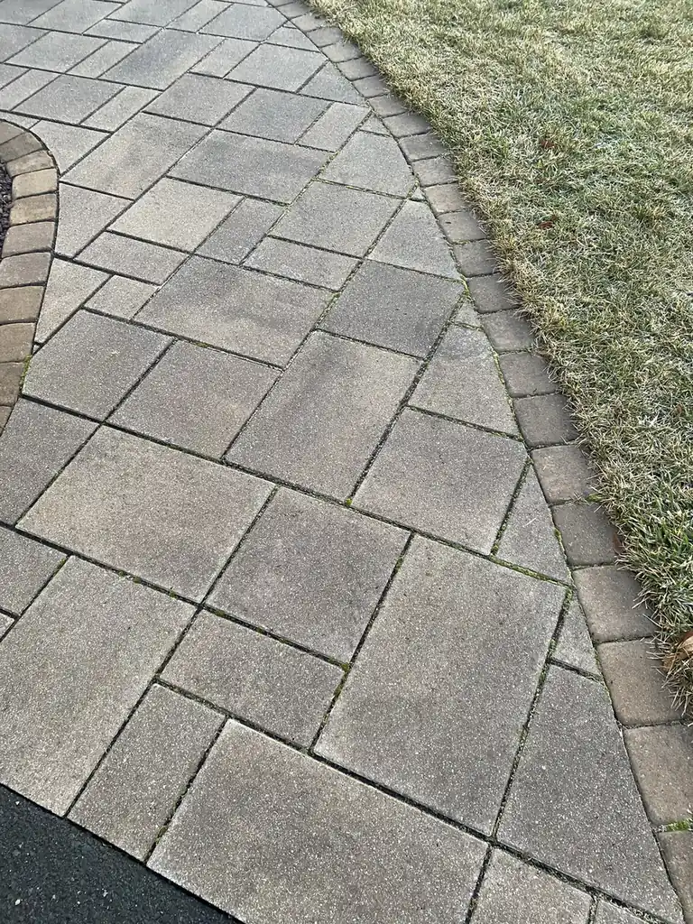 Walkway border detail Close-up of a gray paver walkway and charcoal soldier border with clean joints in Plainville, CT