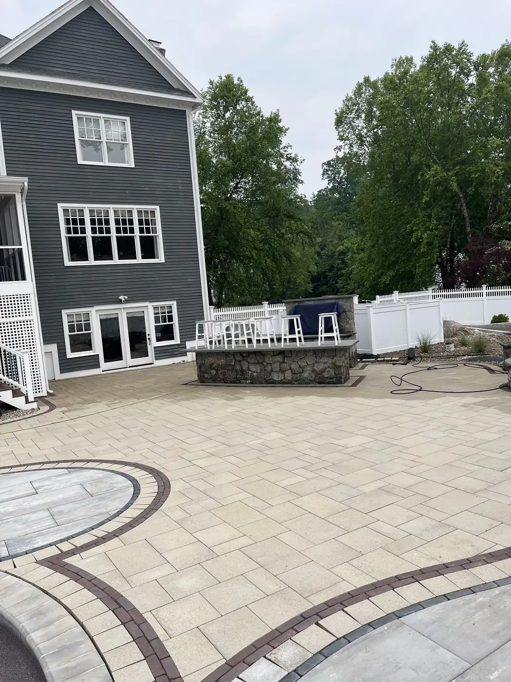Sealed pool patio, Avon Sealed paver pool patio with curved inlay bands looking toward the home in Avon, CT