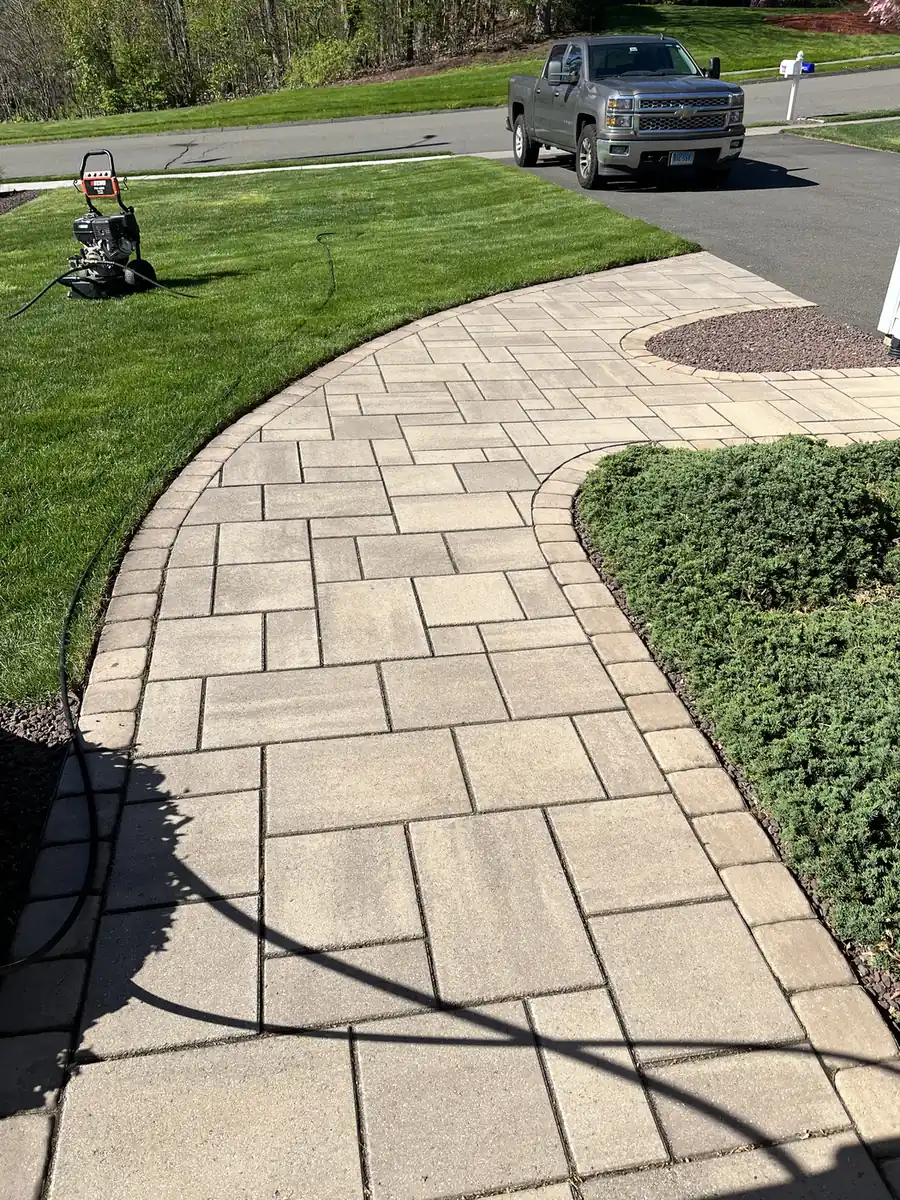 Pressure washer staged on the lawn beside a freshly washed slab paver walkway in Plainville, CT