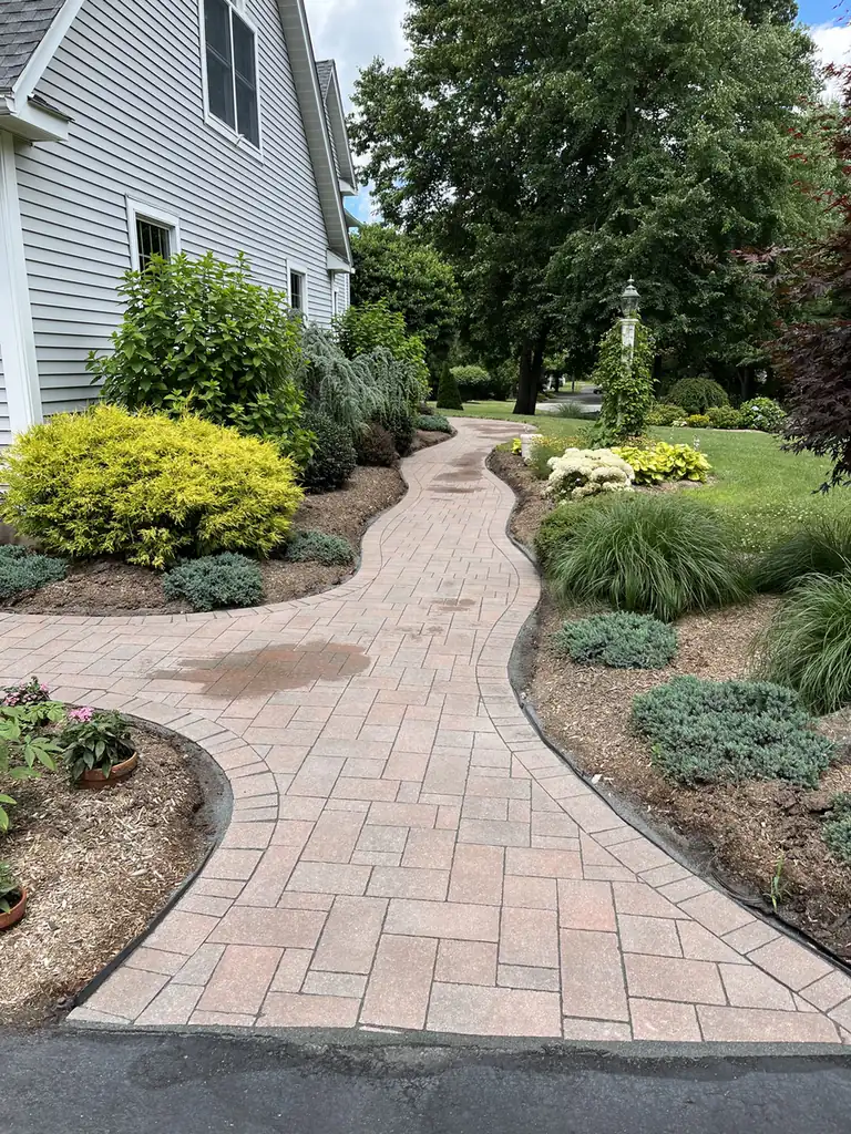Garden walkway, South Windsor Rose-toned paver walkway with a charcoal border winding through garden beds in South Windsor, CT