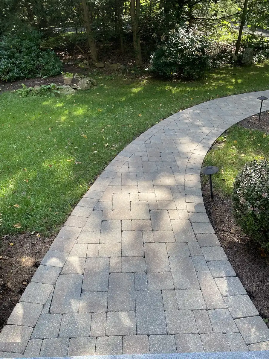Shaded walkway, Farmington Shaded paver walkway curving across a lawn after cleaning and joint re-sanding in Farmington, CT