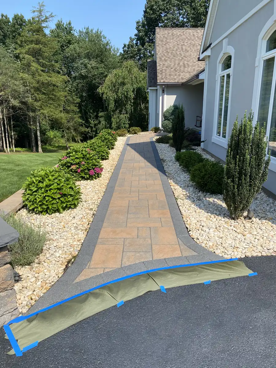 Masked for sealing, Southington Tan slab paver walkway with a charcoal border masked at the driveway before sealing in Southington, CT