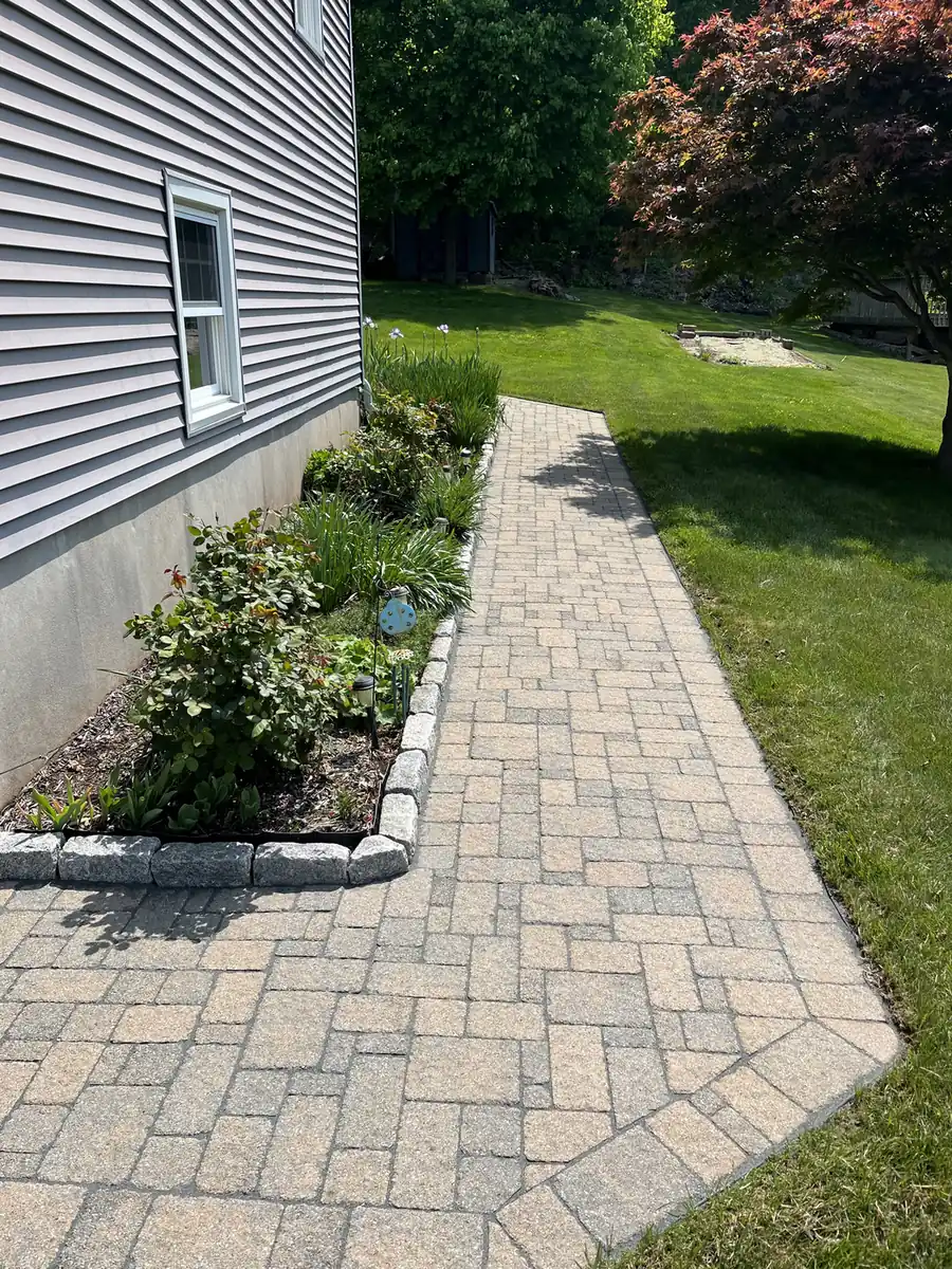 Side-yard walkway, Plainville Side-yard paver walkway with a cobble edge along house siding in Plainville, CT