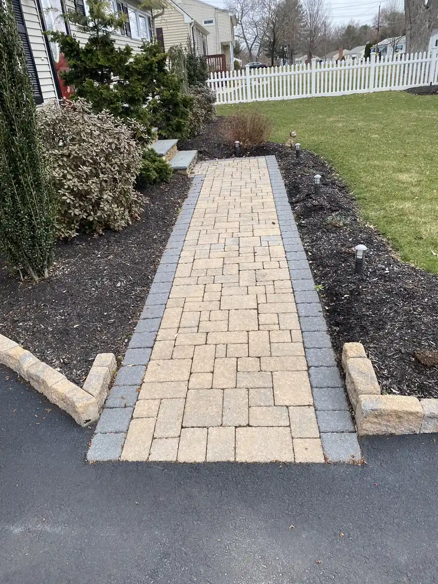 Tan cobble walkway Tan cobble paver walkway with a gray border between mulch beds, re-sanded in Southington, CT