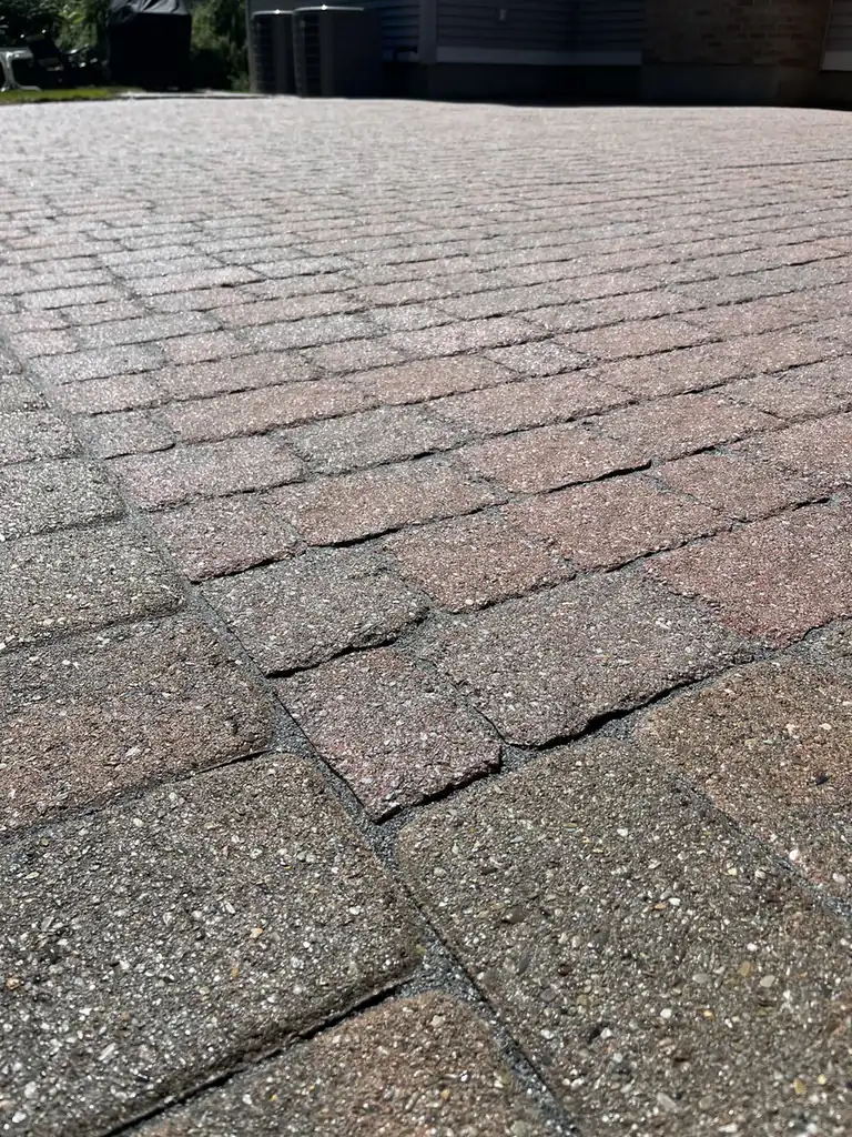 Refilled paver joints Close-up of red and charcoal tumbled pavers with joints refilled with polymeric sand in Southington, CT