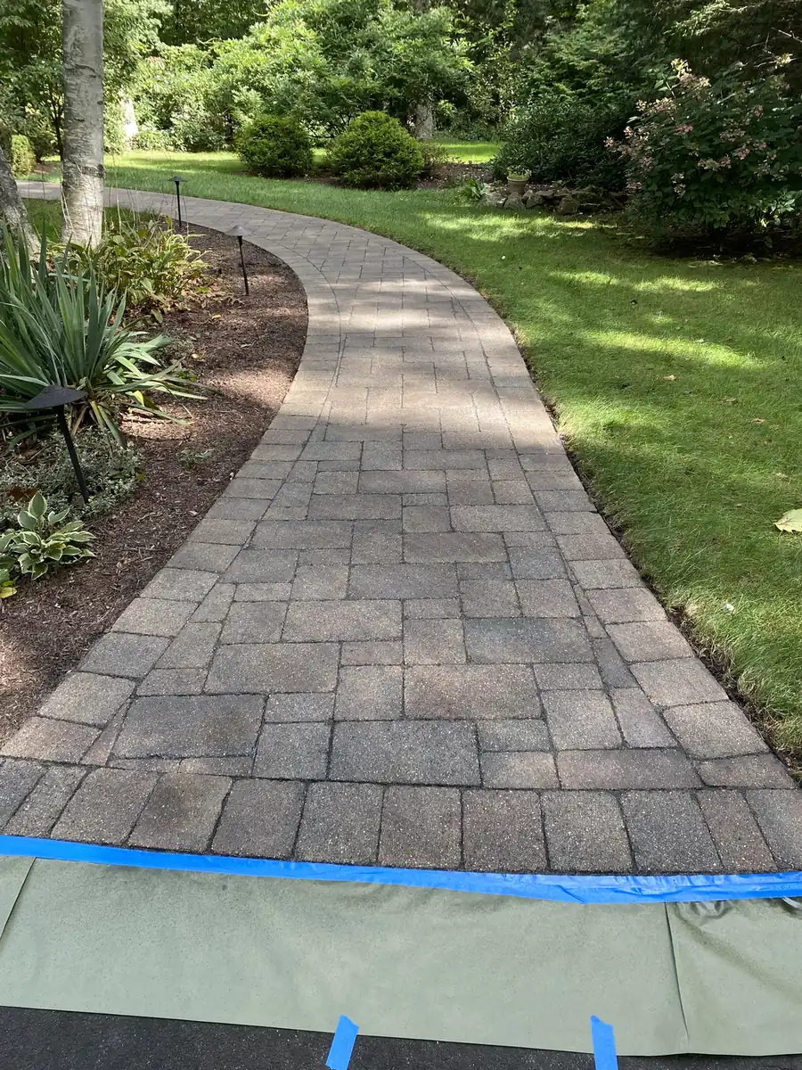 Masked for sealing, Farmington Paver walkway masked with tape and plastic at the driveway edge before sealer is applied in Farmington, CT