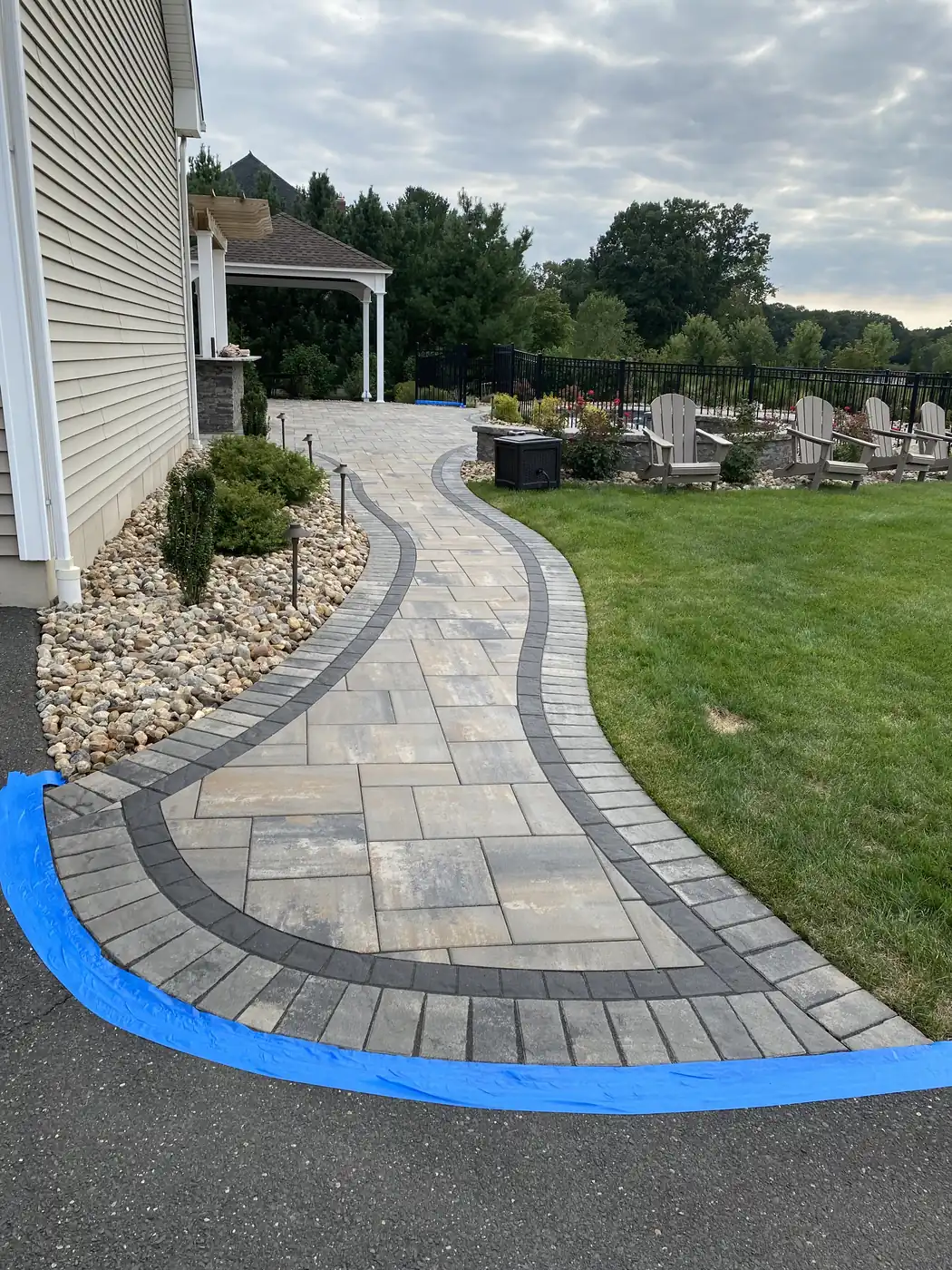 Taped for sealing, Cromwell Winding paver walkway with blue tape protecting the driveway before sealing in Cromwell, CT