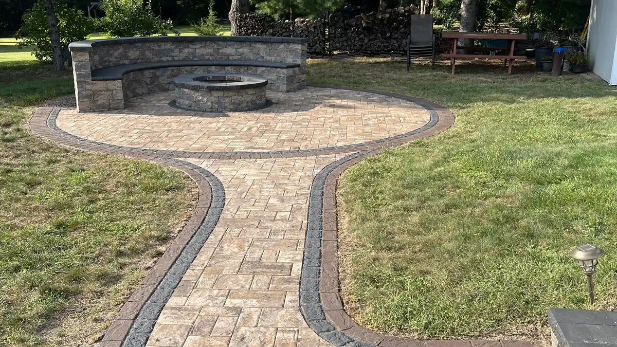 Fire pit patio, Burlington Winding paver path and fire pit patio with a curved stone seat wall after sealing in Burlington, CT